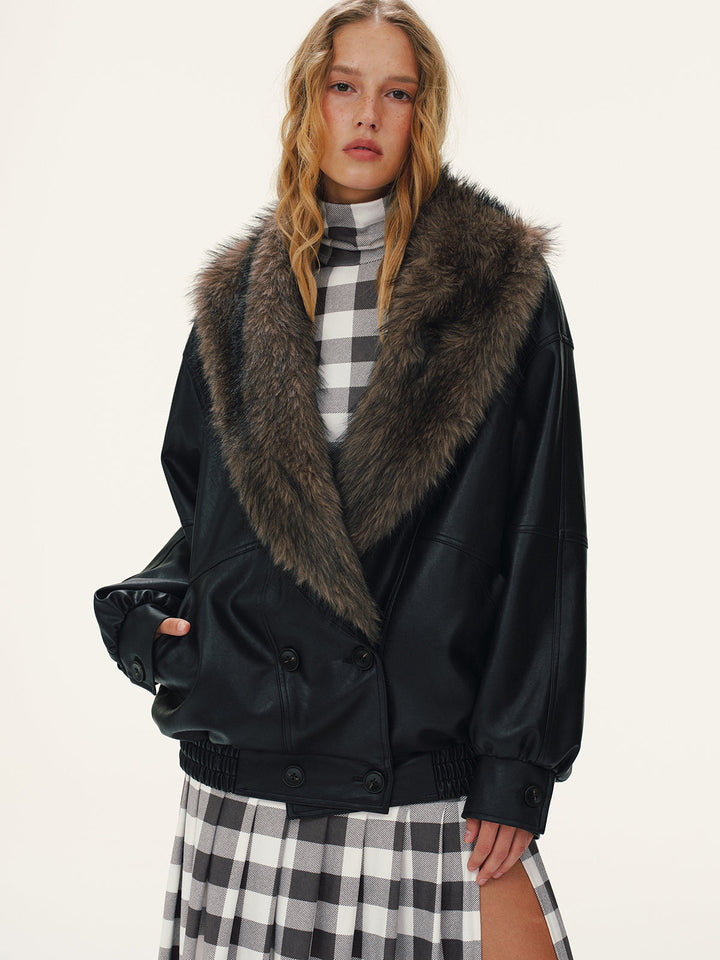 Oversized leather jacket with wide fur shawl collar, worn with a checked maxi skirt