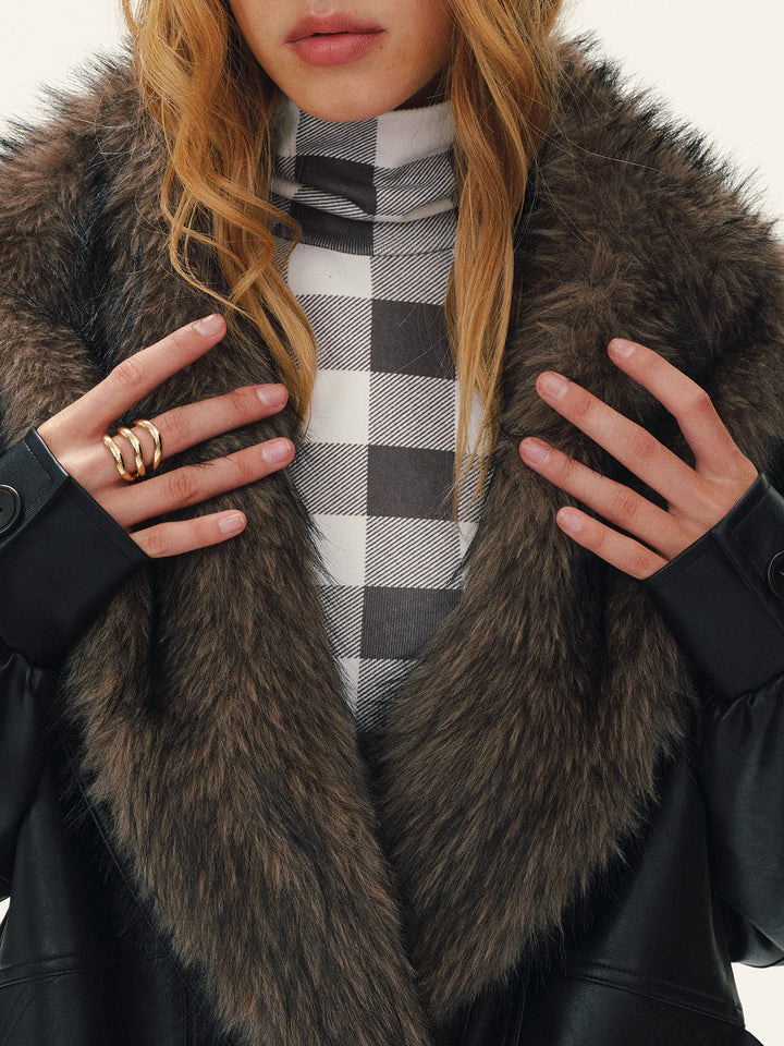 Close-up of the removable brown faux fur collar over a grey checked turtleneck