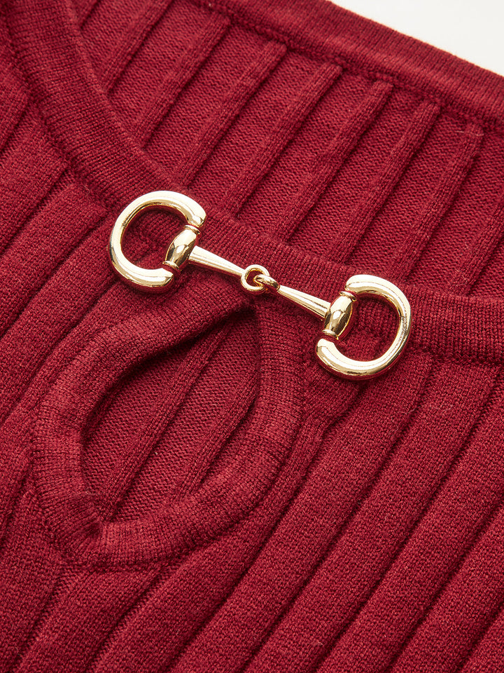 Close-up of the polished gold horsebit hardware at the neckline of the red knit dress