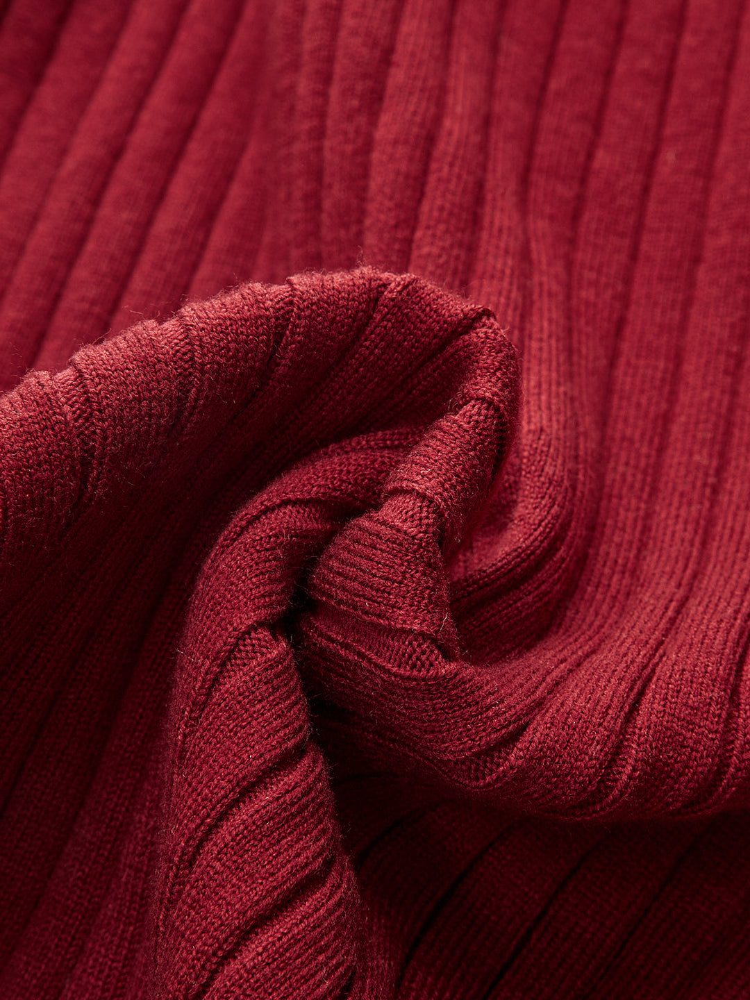 Macro of the deep red ribbed knit fabric used for the bell sleeve midi dress