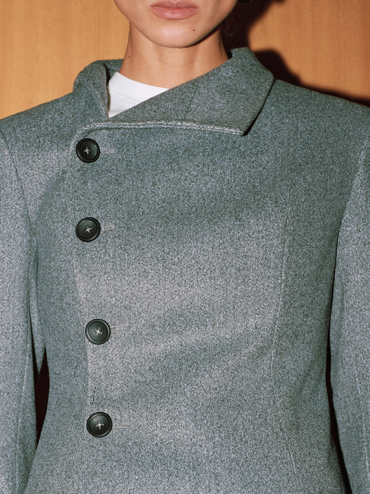Close-up of the slanted button placket and folded collar on grey melange fabric
