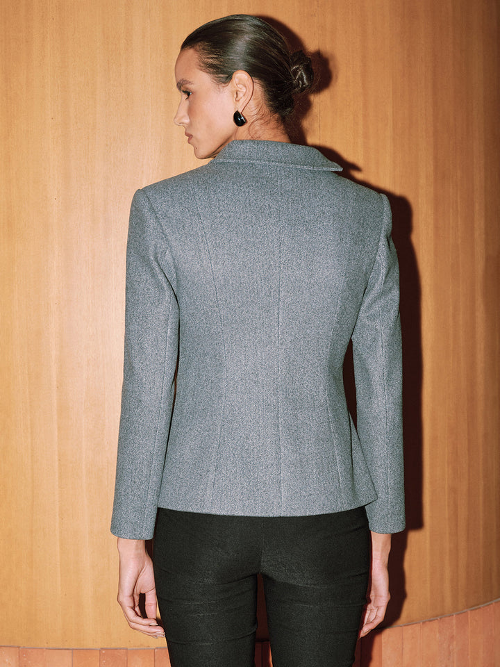Back view of the fitted grey short coat with sharp shoulder line