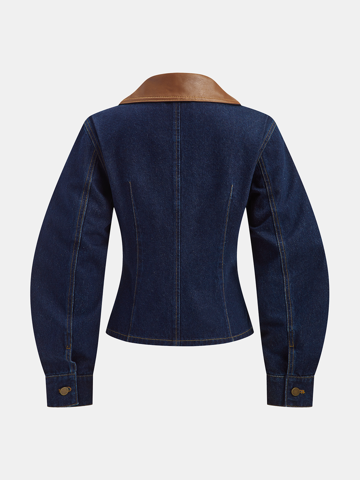Back view of fitted indigo denim jacket with curved sleeves and princess seams