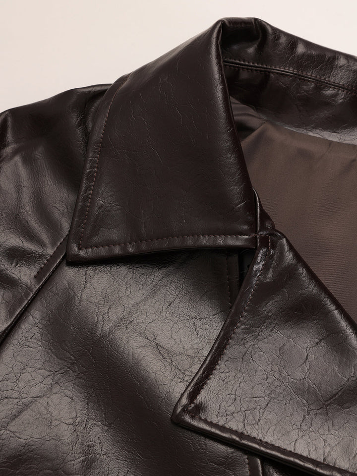 Detail of the wide collar and open lapel of the dark brown vegan leather trench