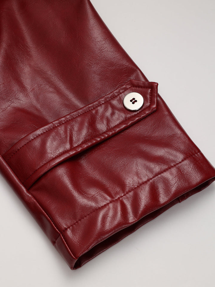 Cuff detail of red leather look trench coat with buttoned sleeve strap and white button
