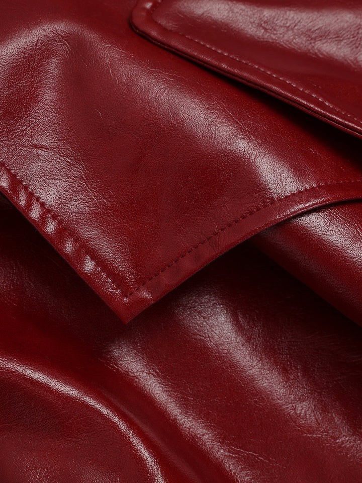 Detail of the wide notch lapel and topstitched edge on the burgundy faux leather trench coat