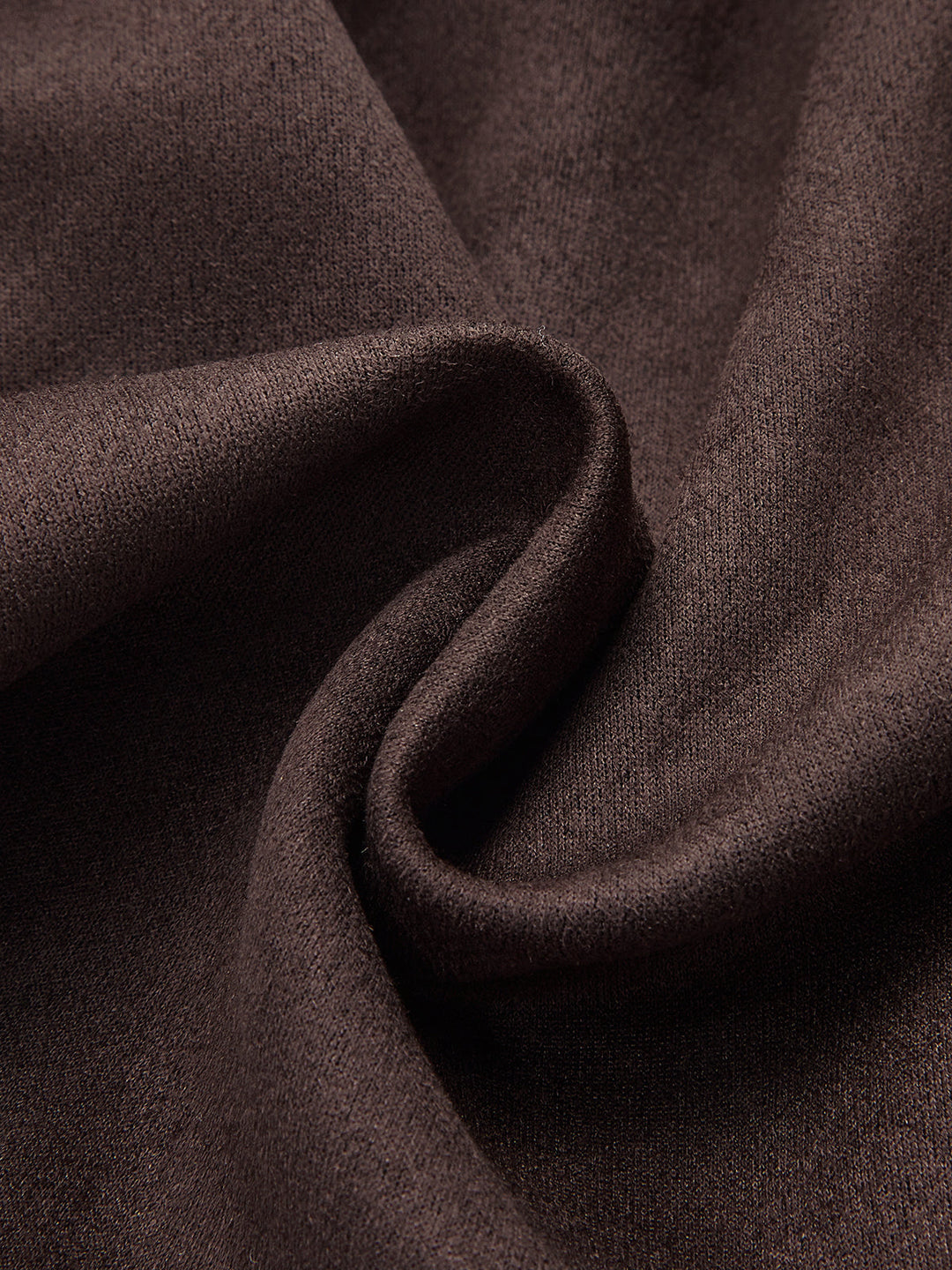Macro of the soft brown brushed suede fabric draped in folds