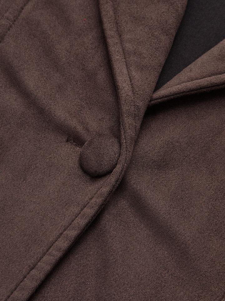 Close-up of the covered button and shawl lapel edge on the belted brown jacket