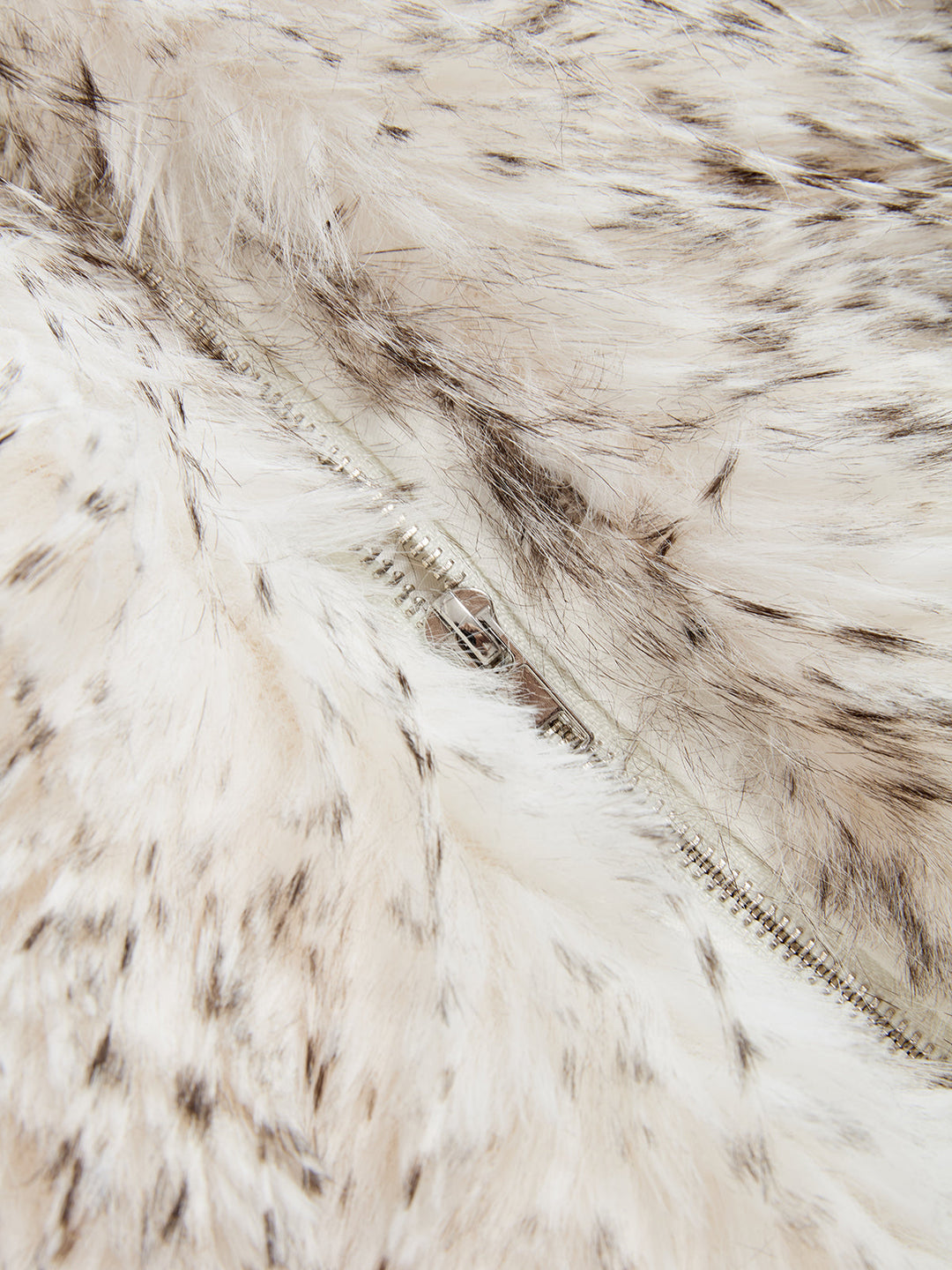 Close-up of the concealed zip front hidden in the faux fur of the sleeveless vest