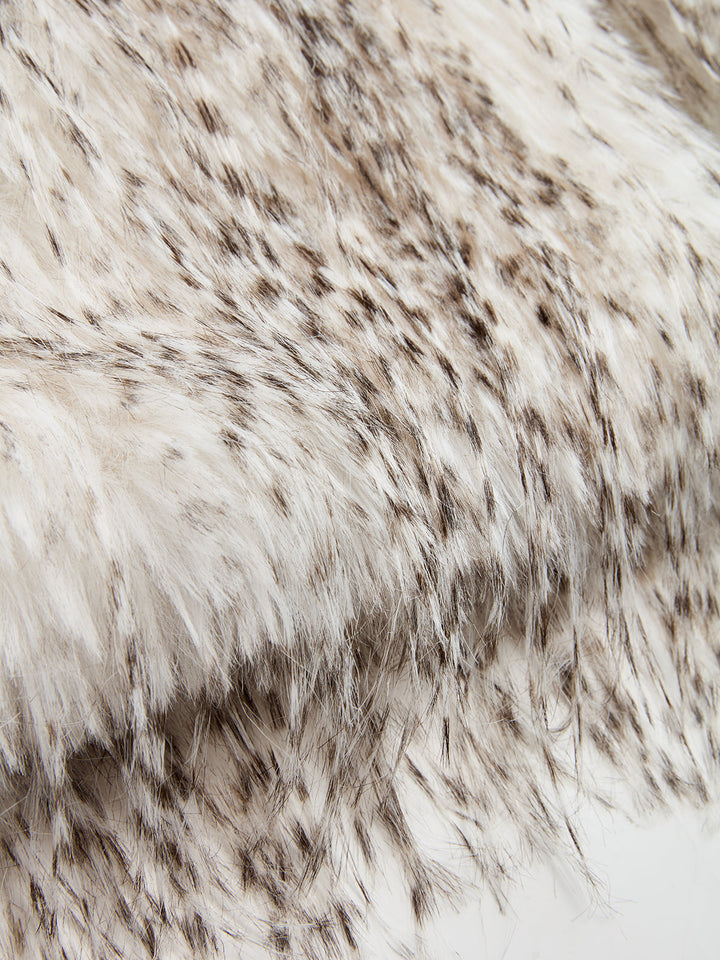 Texture detail of the soft ivory faux fur with dark tips used for this belted gilet