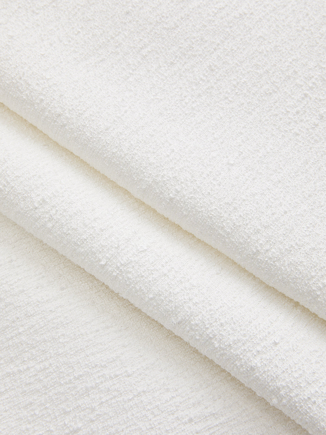 Macro of the white boucle textured fabric used for this jeweled short sleeve top