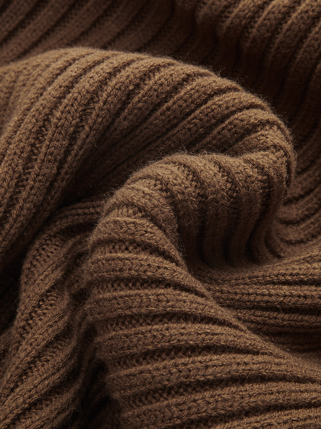 Macro texture detail of chunky brown ribbed knit fabric