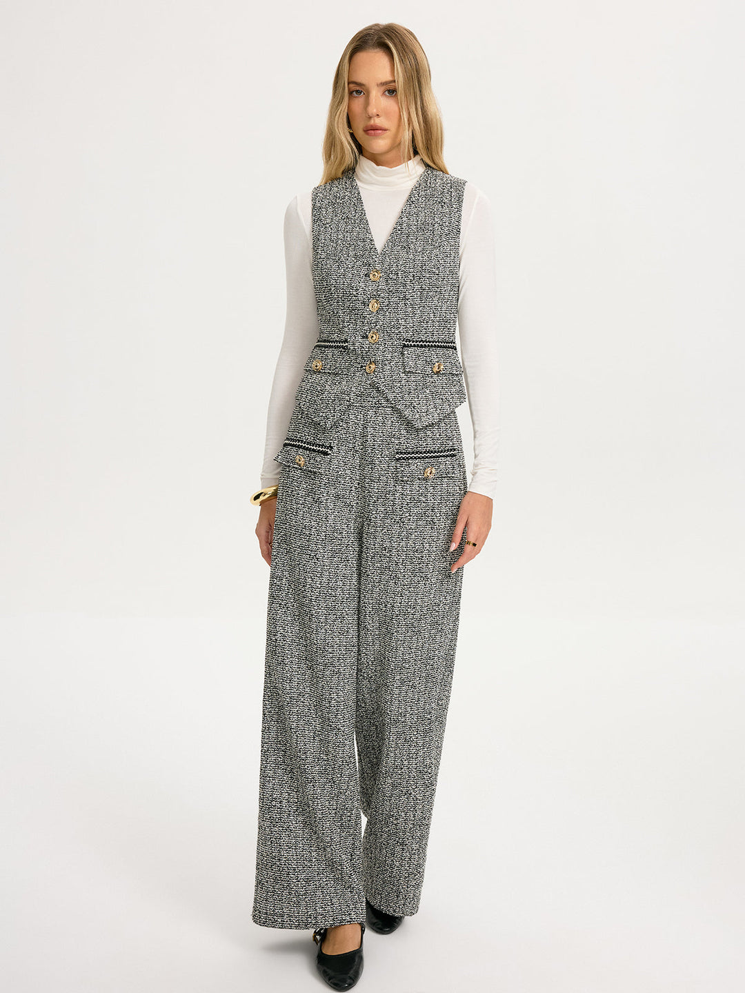 Full-length grey herringbone tweed vest and wide-leg trouser suit with black heels