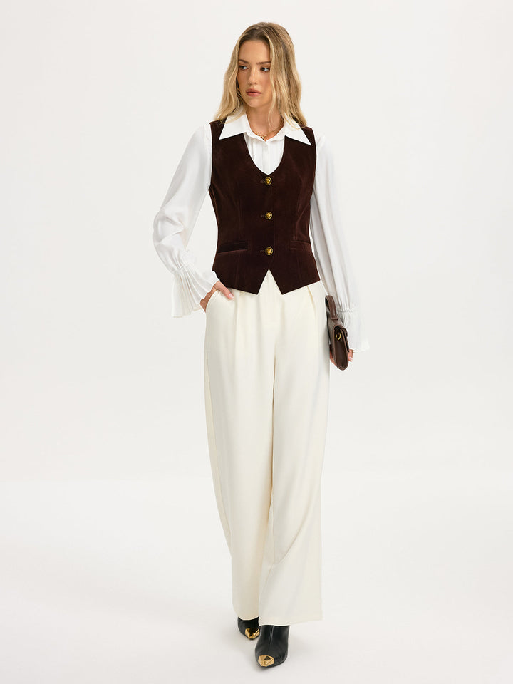 Full-length look with velvet waistcoat, white blouse, ivory wide-leg trousers and black loafers
