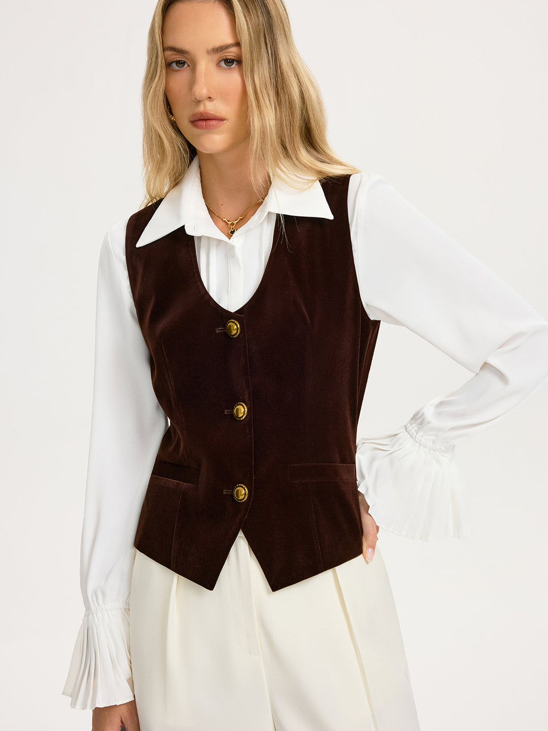 Front view of the fitted brown velvet vest showing the curved hem and slim waist seams