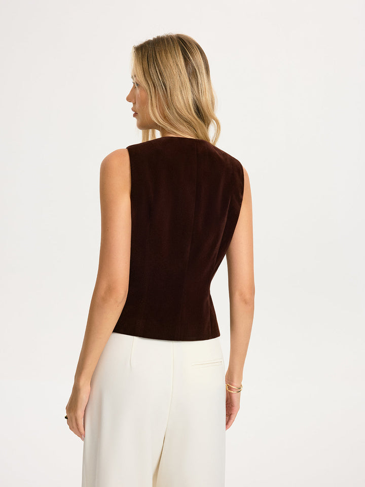 Back view of the dark brown velvet sleeveless vest with clean centre seam and sloped armholes