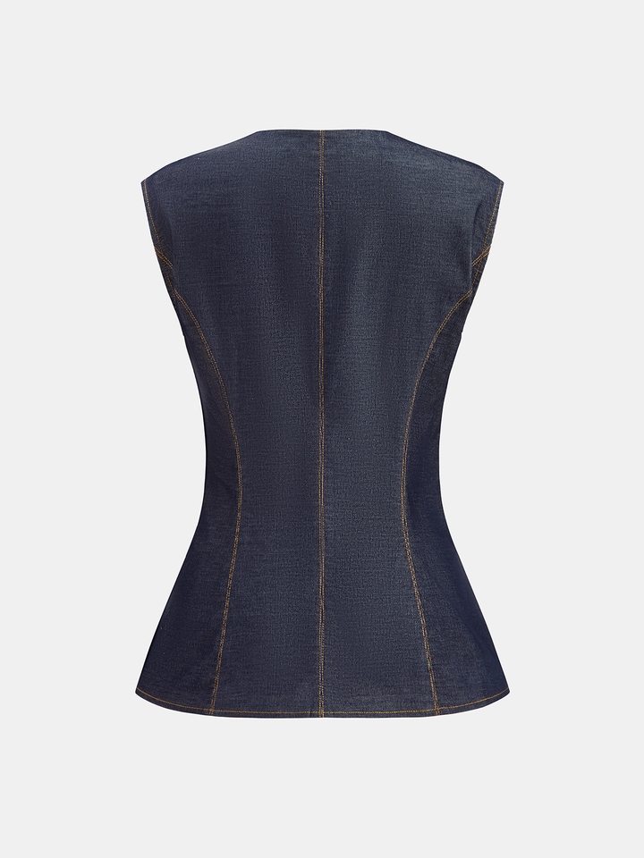 Back view of fitted navy denim vest showing princess seams and nipped waist