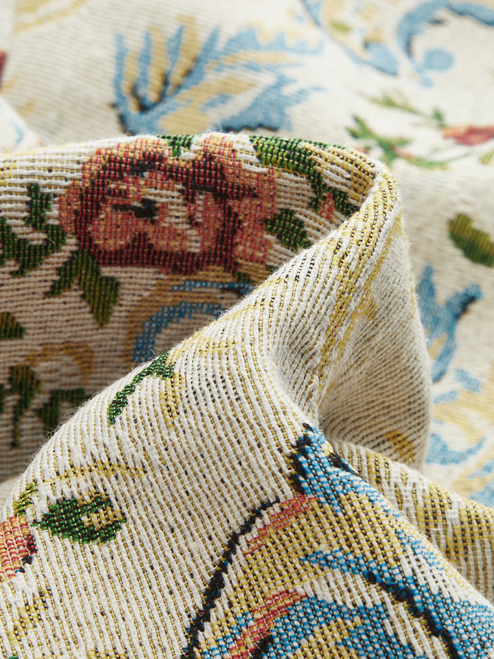 Close-up of woven rose and scroll tapestry fabric on vintage floral vest