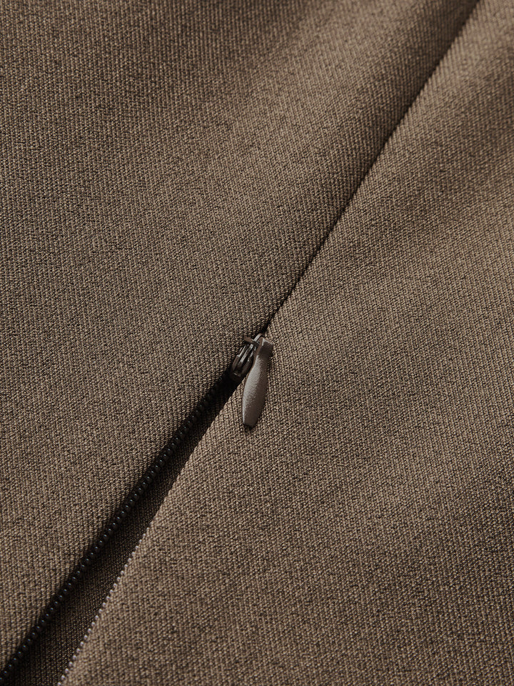 Macro of the hidden side zip and fine brown woven fabric of the vest