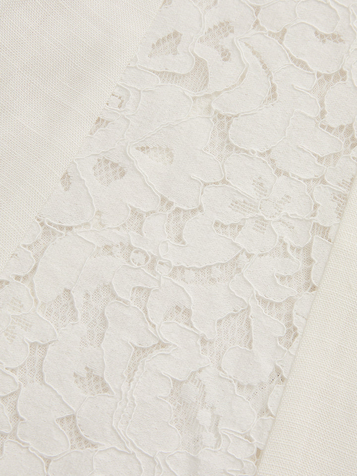 Detail of the floral lace side panel set into the cream linen blend vest