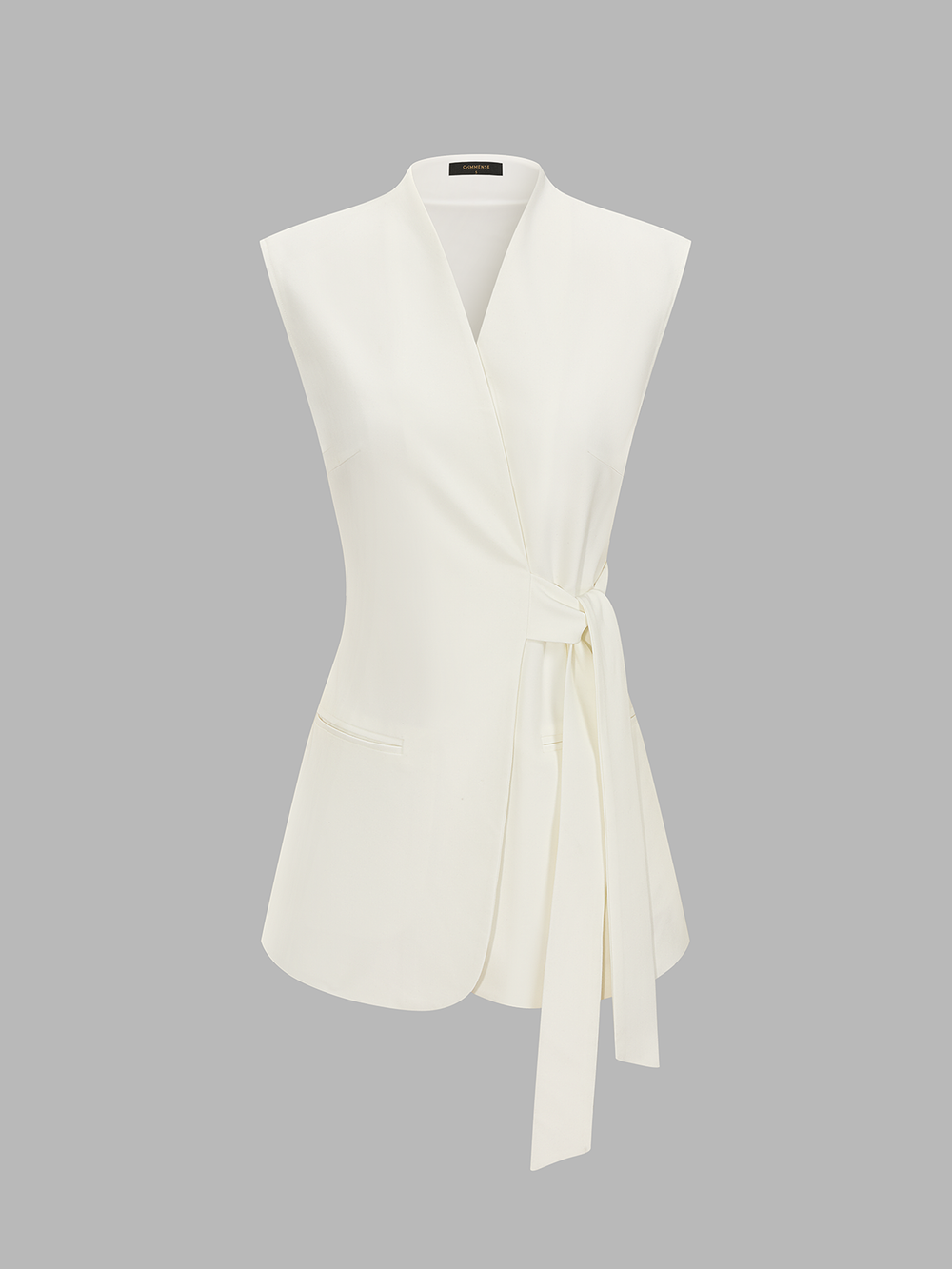Ivory tie-waist wrap blazer vest front view with V neckline, welt pockets and a long waist tie