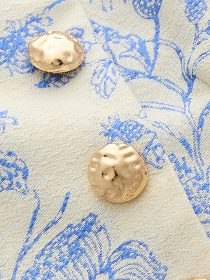 Close-up of hammered gold metal buttons on blue and cream floral jacquard