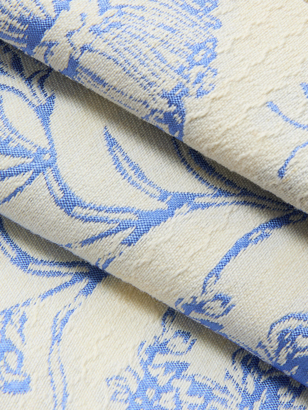 Macro of textured blue floral jacquard weave used for the halter neck vest