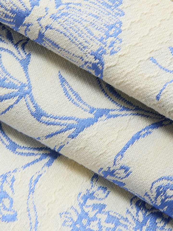 Macro of textured blue floral jacquard weave used for the halter neck vest