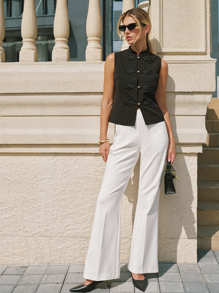 Full length shot of black sleeveless mandarin vest with white trousers and black heels
