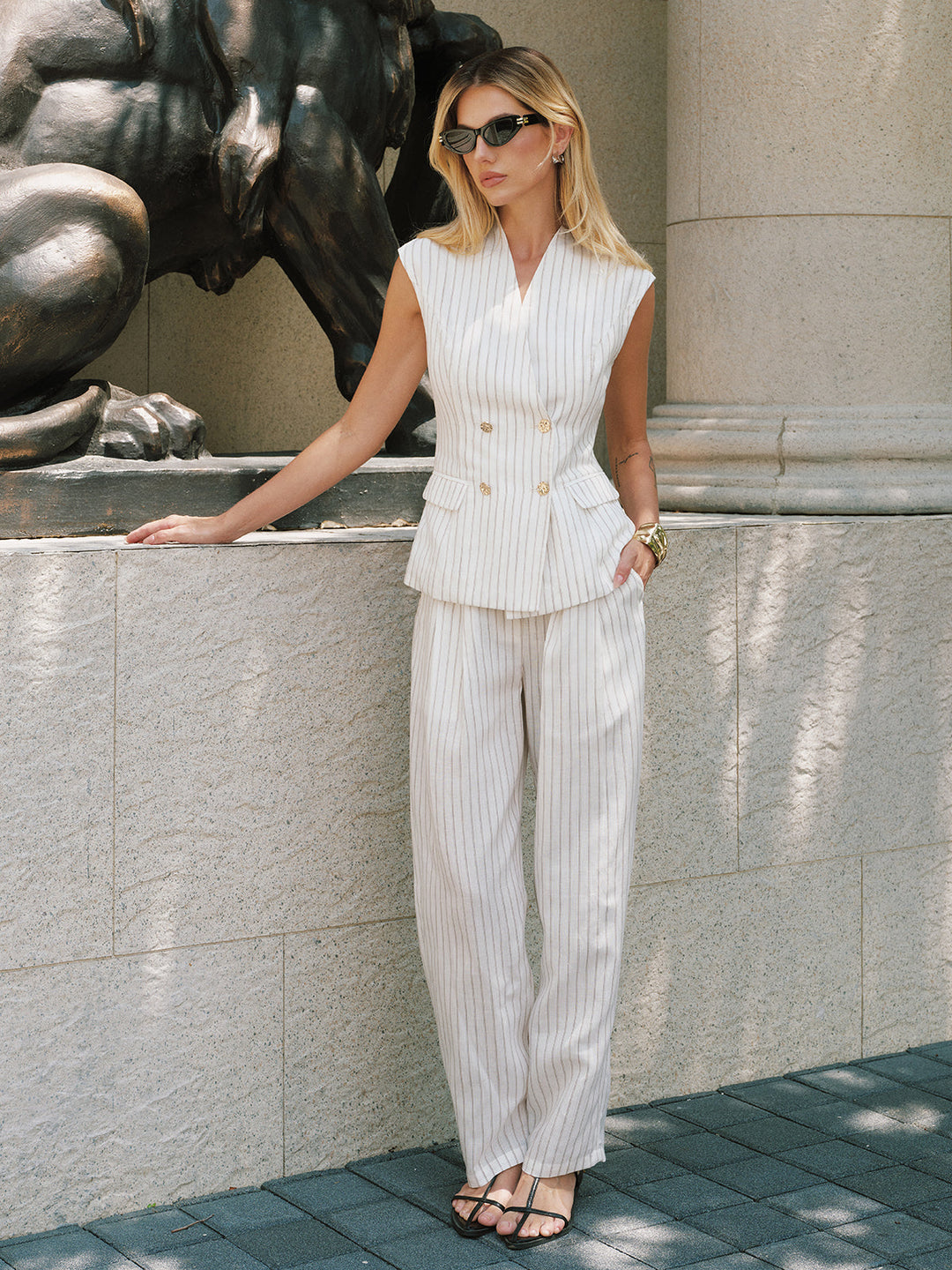 Full length street shot of the pinstripe vest and matching wide leg trouser suit