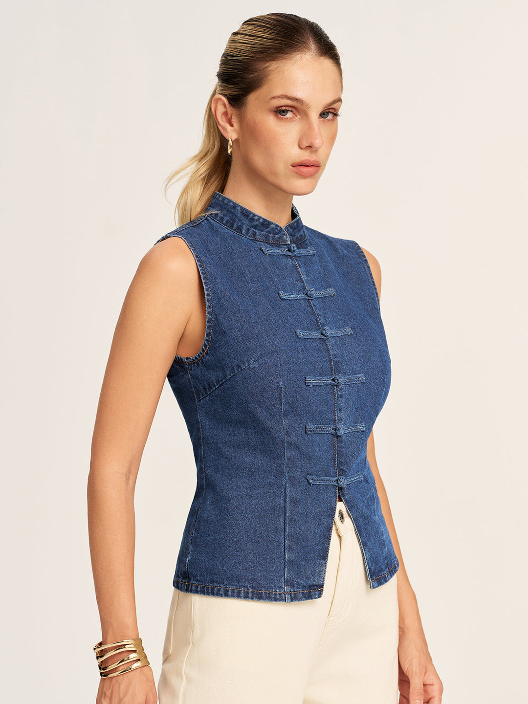 Three quarter view of the blue denim mandarin collar vest showing shaped side seams