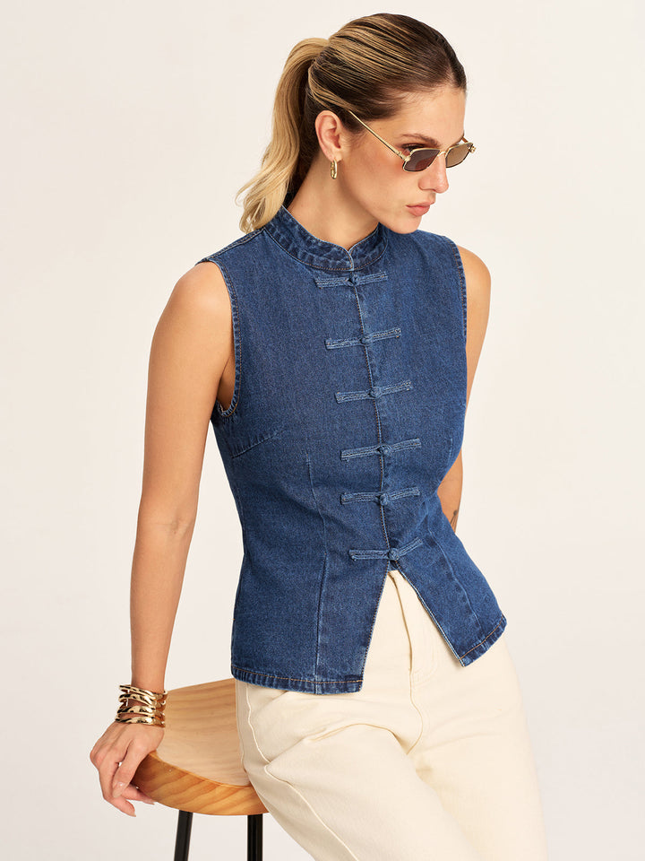 Model in blue denim mandarin collar vest with frog buttons and cream wide leg jeans