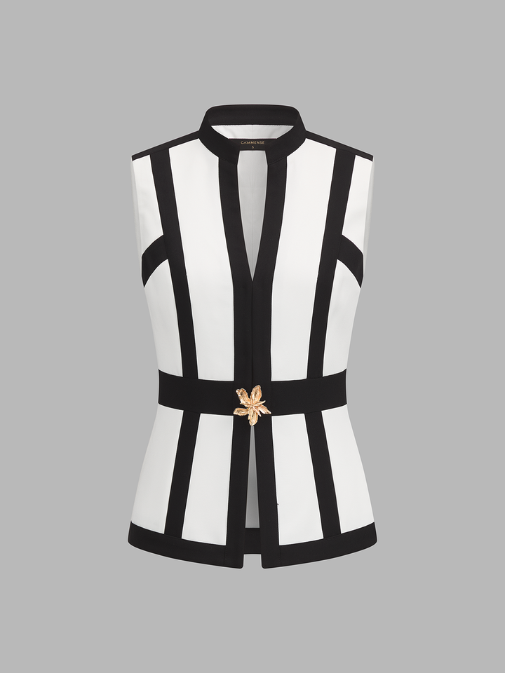 Front view of white stand collar vest with black contrast panels and gold floral buckle