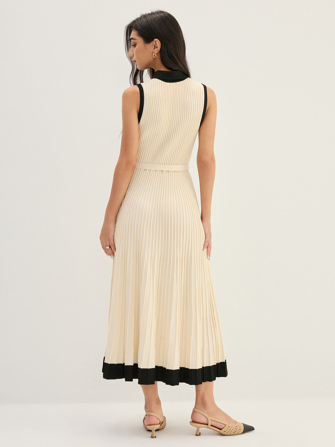 Back view of ivory pleated knit maxi dress with black contrast hem band