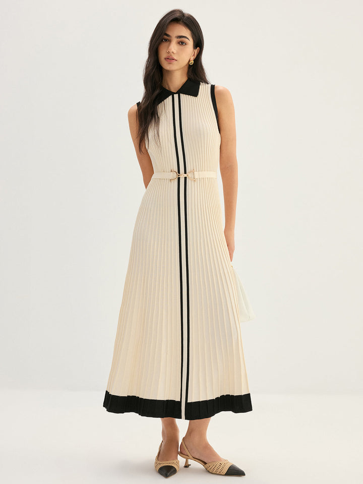 Full length view of ivory pleated knit maxi dress with black hem trim and belt