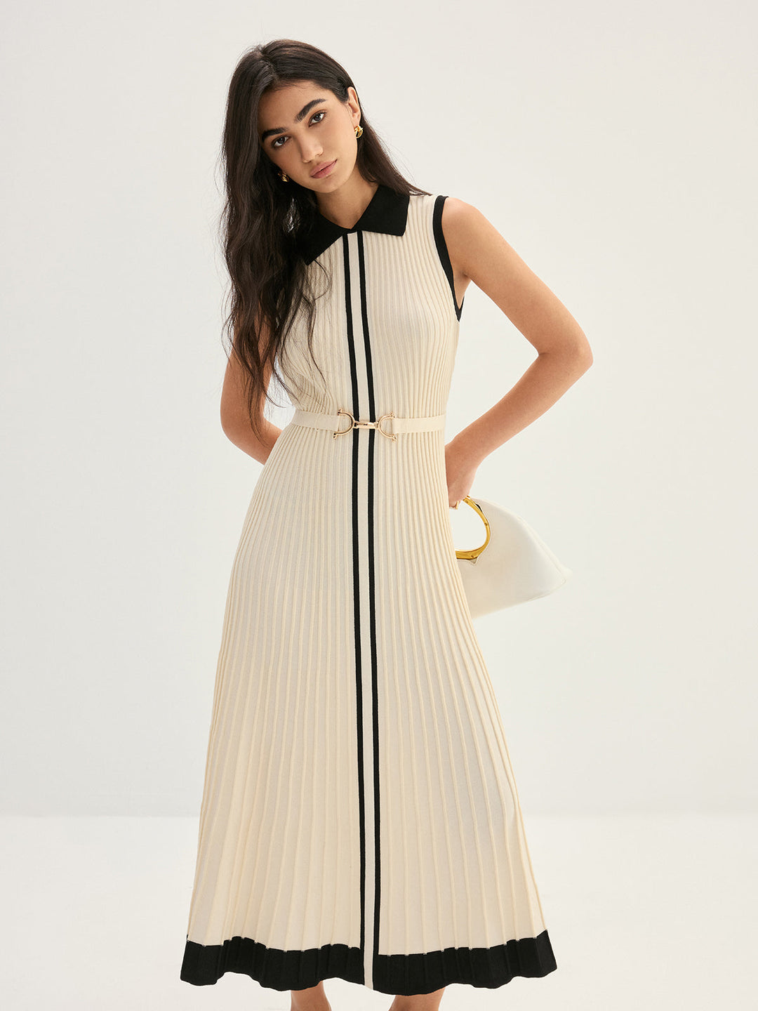 Model in cream contrast collar knit maxi dress holding white leather handbag