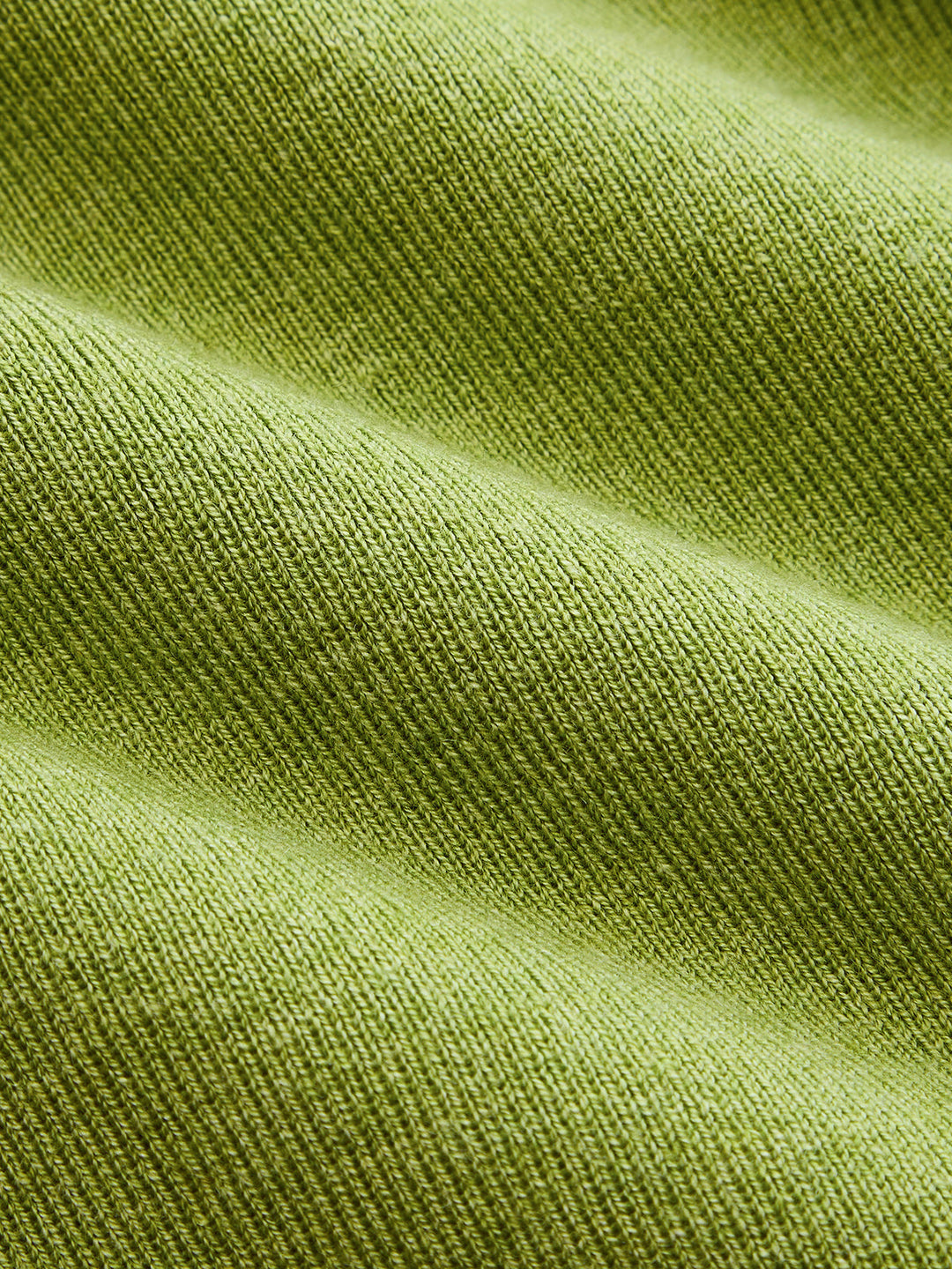 Macro of the fine olive green ribbed knit fabric of the button front maxi dress