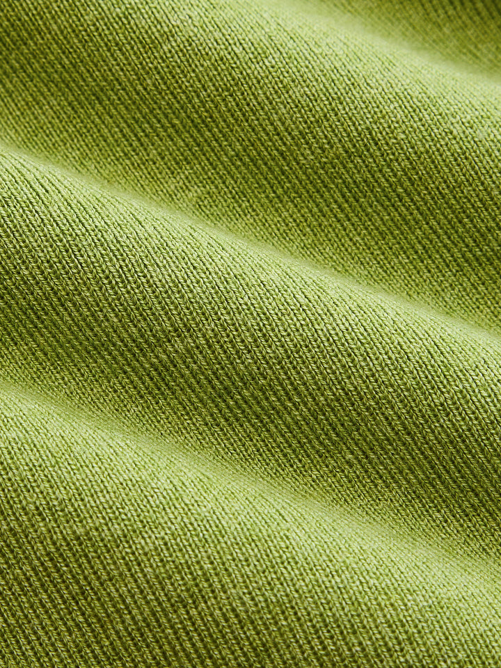 Macro of the fine olive green ribbed knit fabric of the button front maxi dress