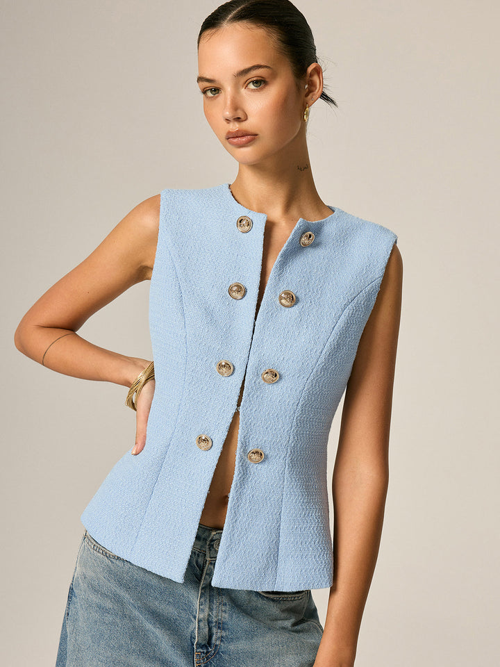 Angled front view of the gold button tweed vest showing the open front and fitted waist