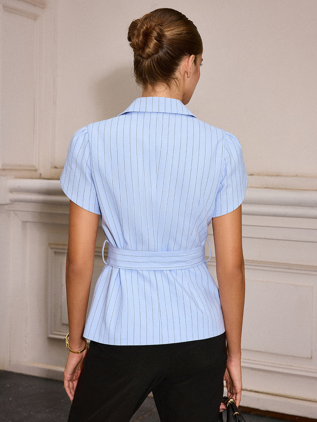 Back view of the pale blue pinstripe belted top with collar and short tulip sleeves