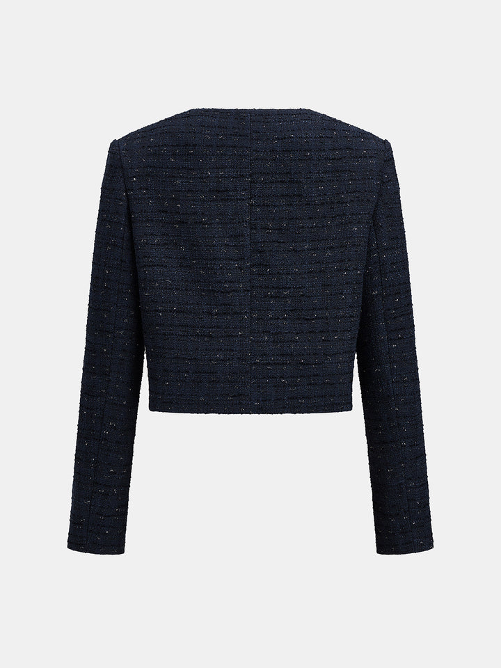 Back view of the dark blue cropped tweed blazer showing the clean collarless neckline