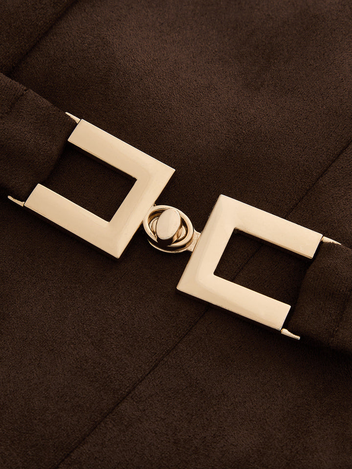 Close-up of cream rectangular belt buckle on the brown suede effect vest