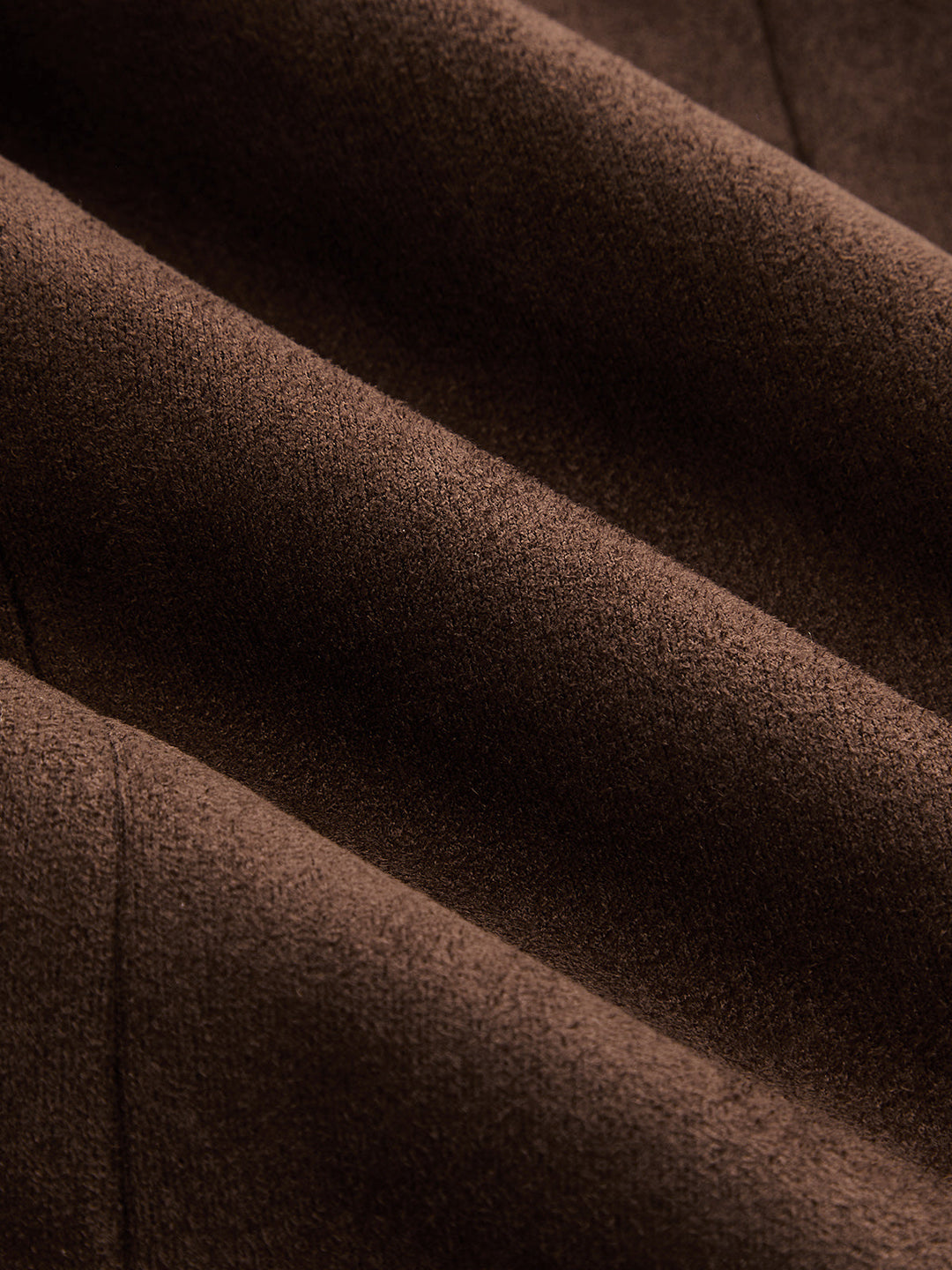 Macro of soft chocolate brown faux suede fabric with velvety nap