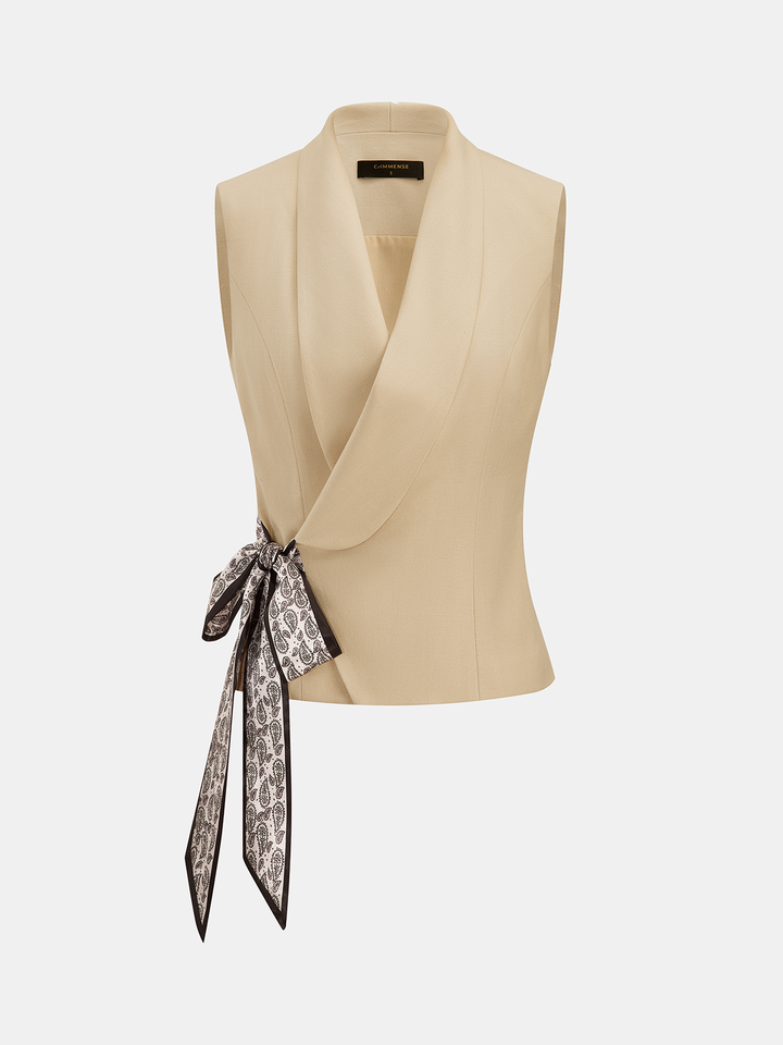 Front view of khaki shawl collar sleeveless vest with long patterned scarf tie at hip