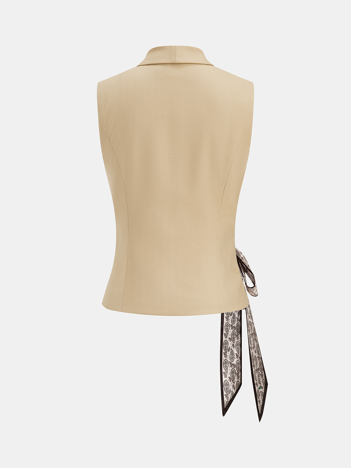 Back view of the beige sleeveless tailored vest with ribbon tie ends hanging loose