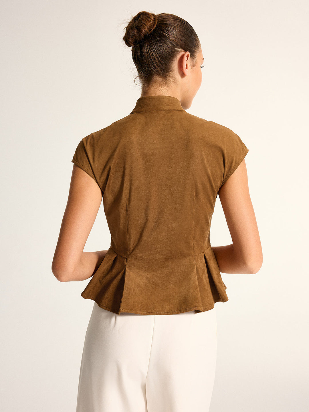 Back view of brown mandarin collar peplum blouse showing fitted waist seams