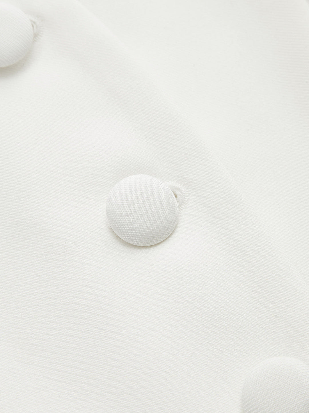 Close-up of self-covered white fabric buttons on the peplum blouse placket
