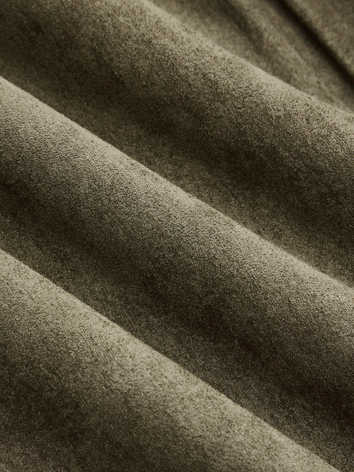 Close-up of the soft olive faux suede fabric showing its matte brushed surface
