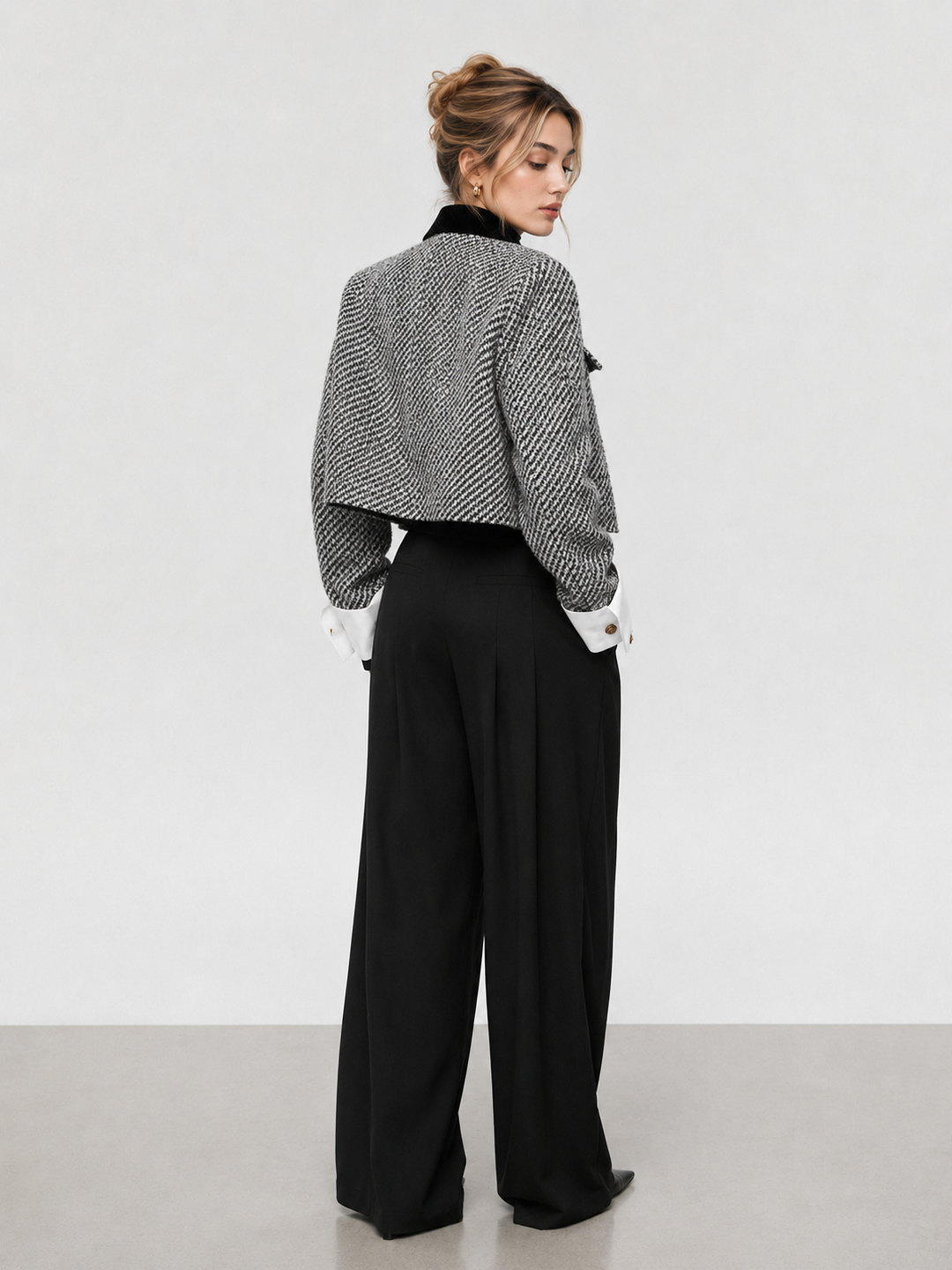 Back view of black and white tweed cropped blazer with boxy shoulders