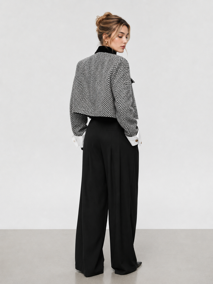 Back view of black and white tweed cropped blazer with boxy shoulders